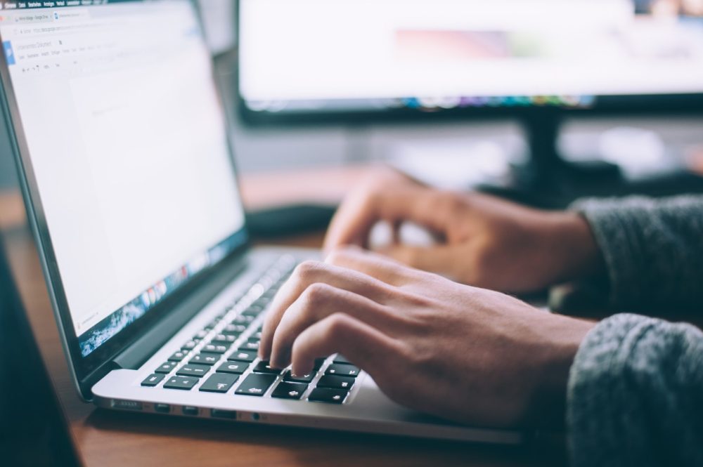 software developer typing on a computer
